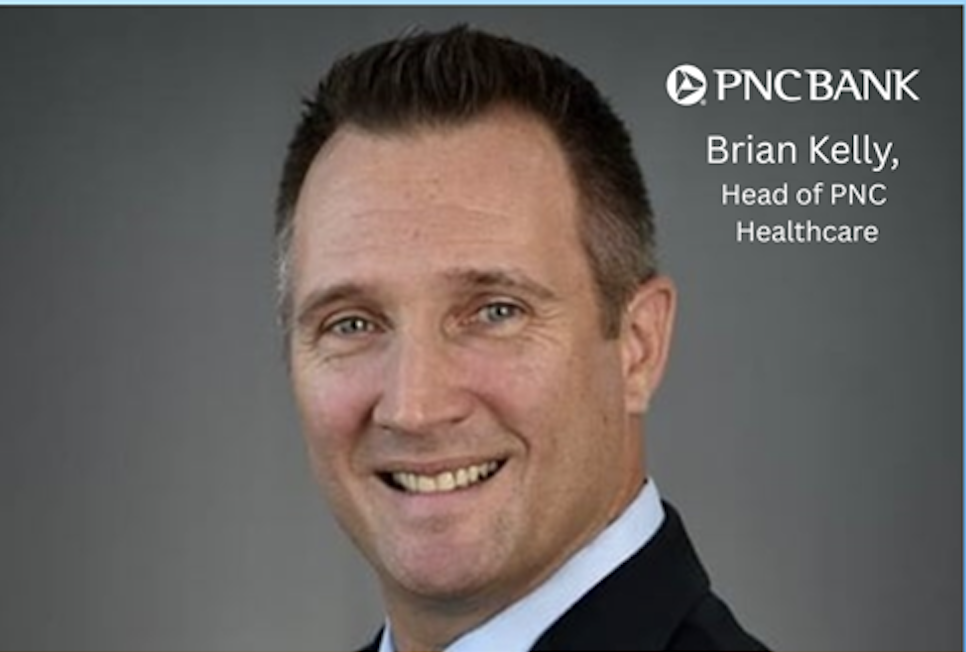 Brian Kelly with logo